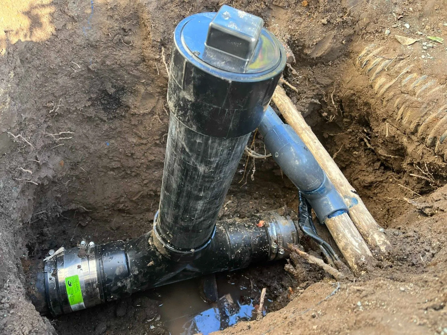 Exterior sewer cleanout exposed during plumbing work