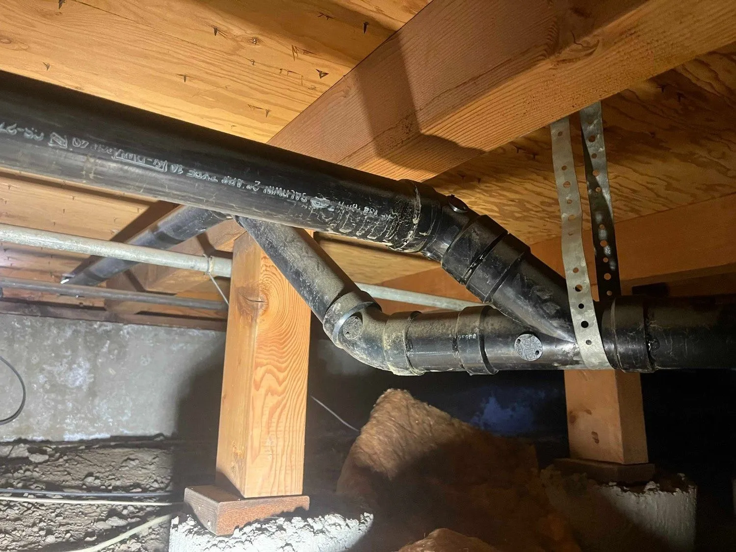 Drain and waste piping under a raised floor