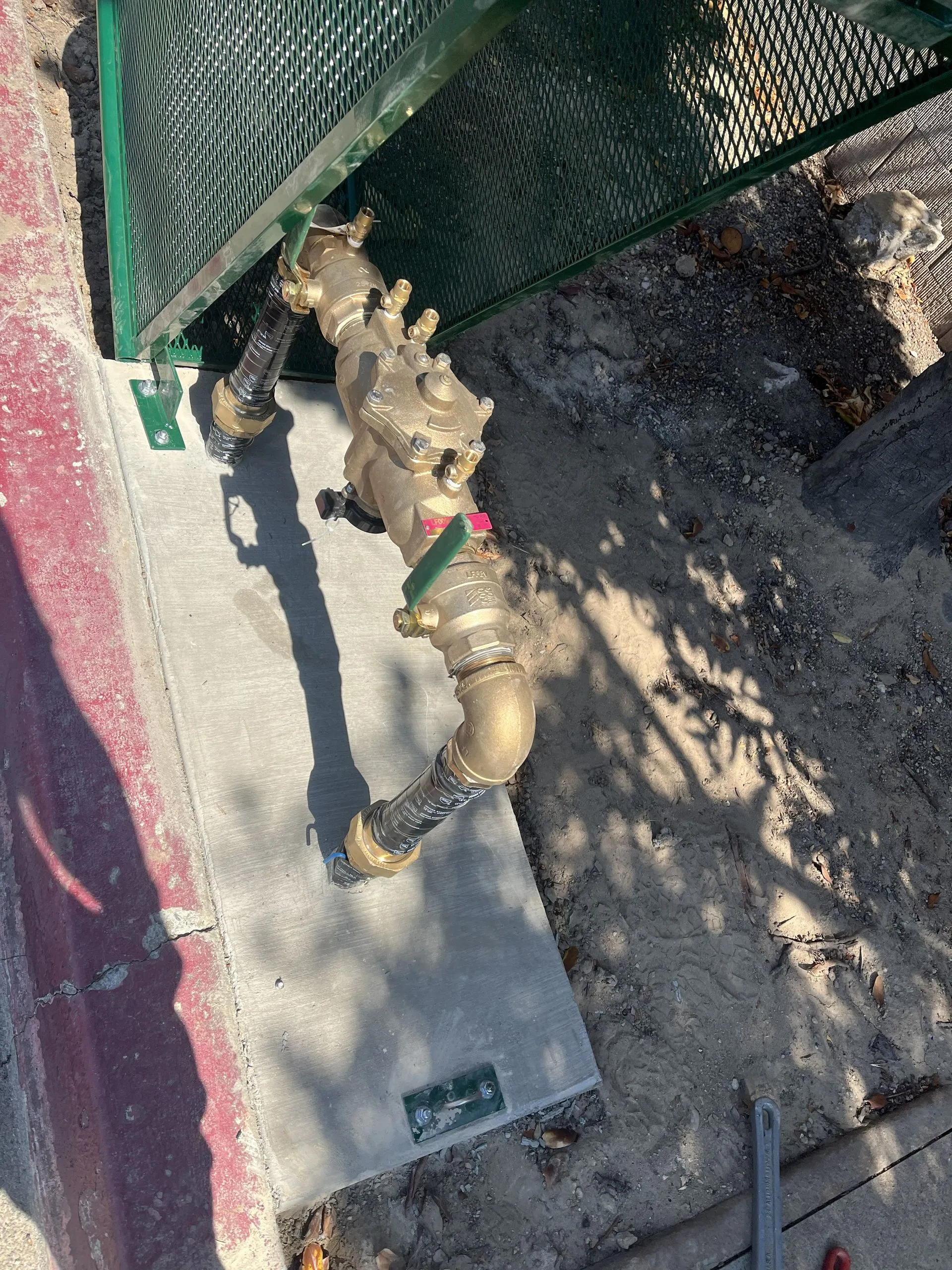 Backflow and valve assembly at an outdoor plumbing connection