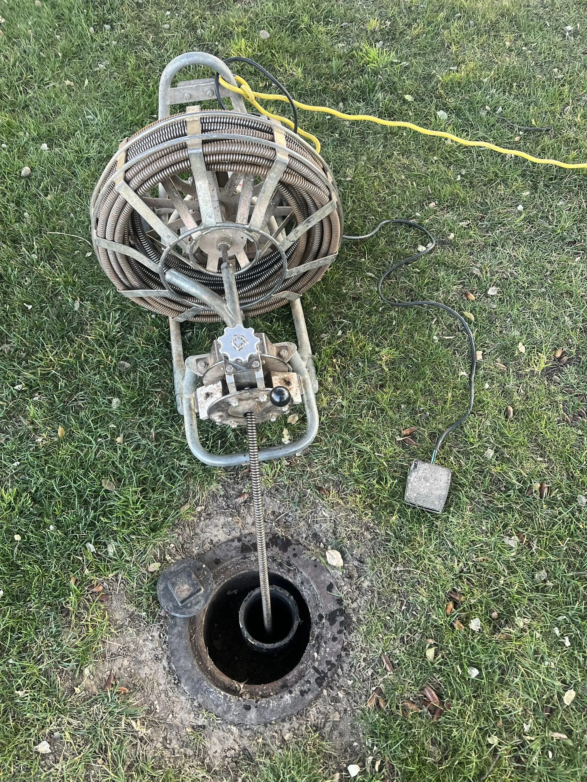 Drain cleaning machine at an exterior cleanout