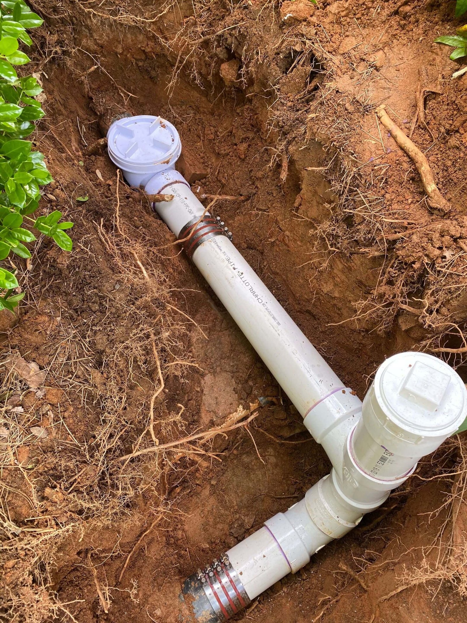PVC sewer line and cleanout exposed during underground repair