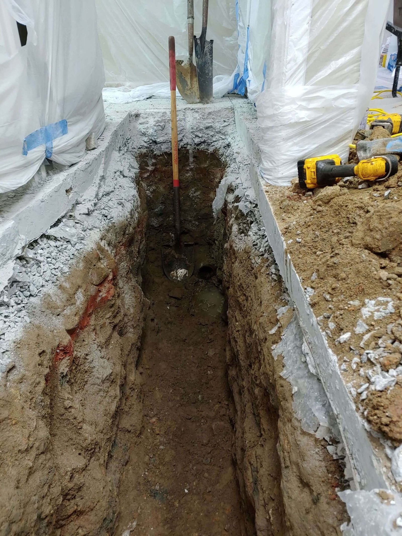 Interior trench opened for underground plumbing work